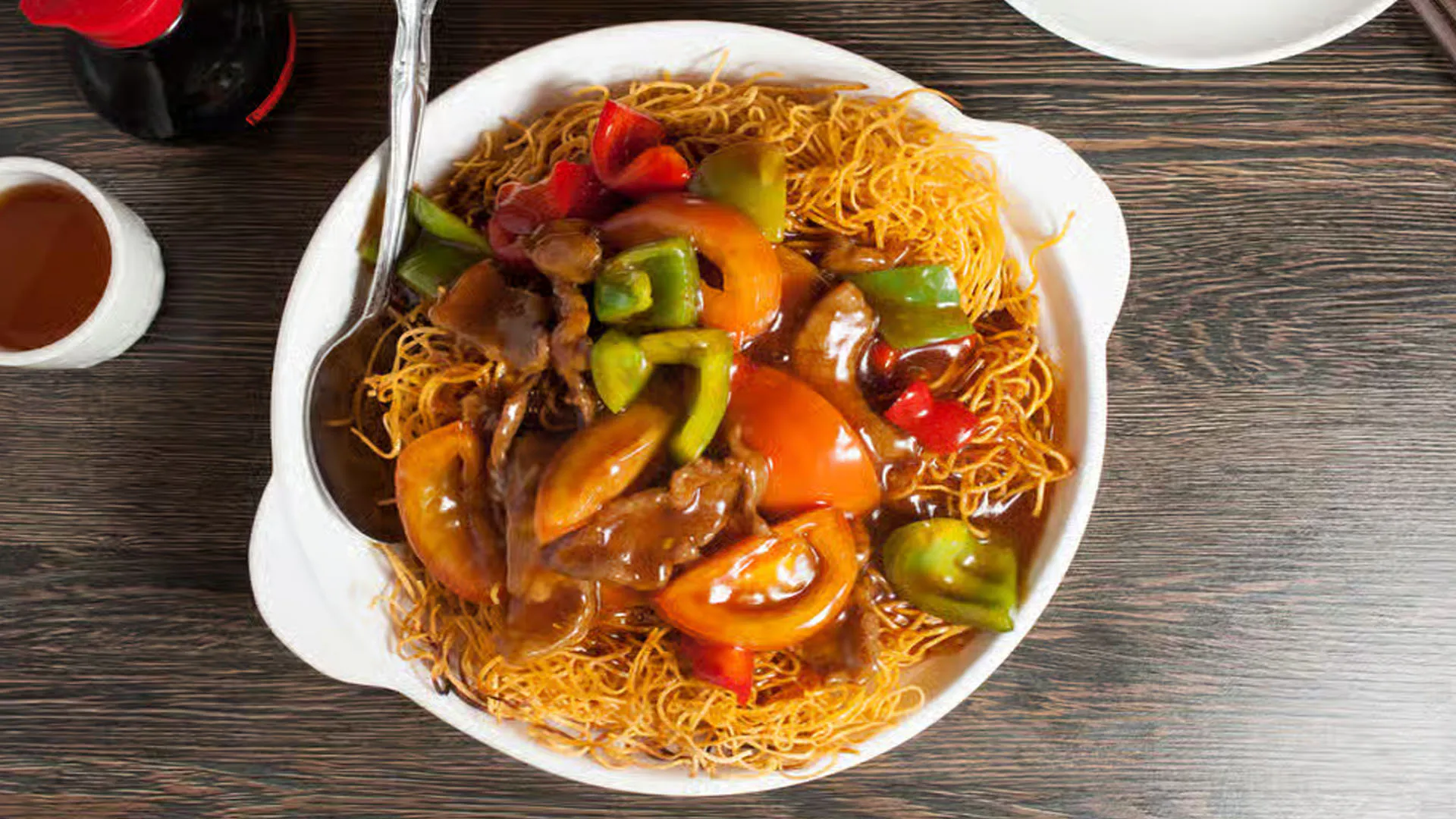 Crispy pan-fried noodles stir-fried with beef and colorful bell peppers at Cheung Hing, a Chinese Restaurant in San Francisco