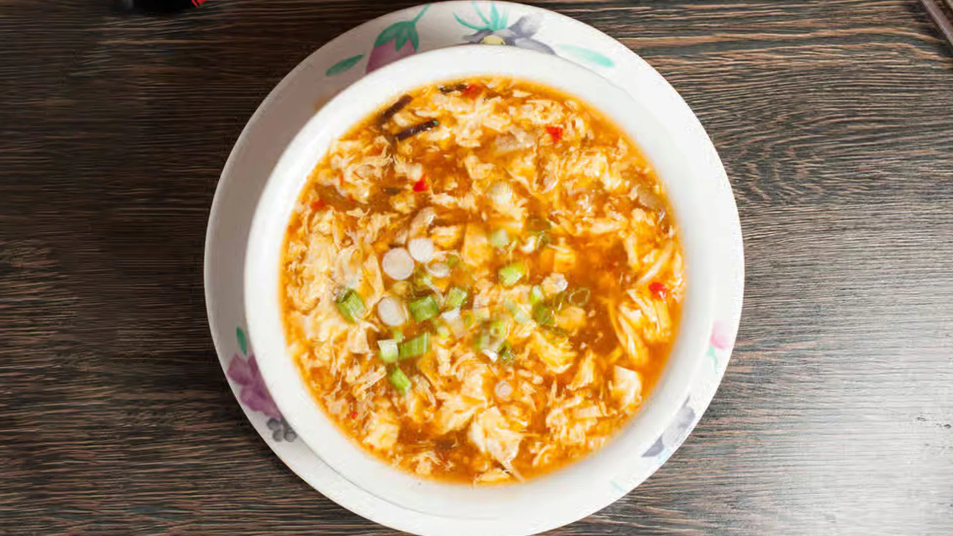 Classic tangy hot and sour soup with tofu, egg and chopped green onions at Cheung Hing, a Chinese Restaurant in San Francisco