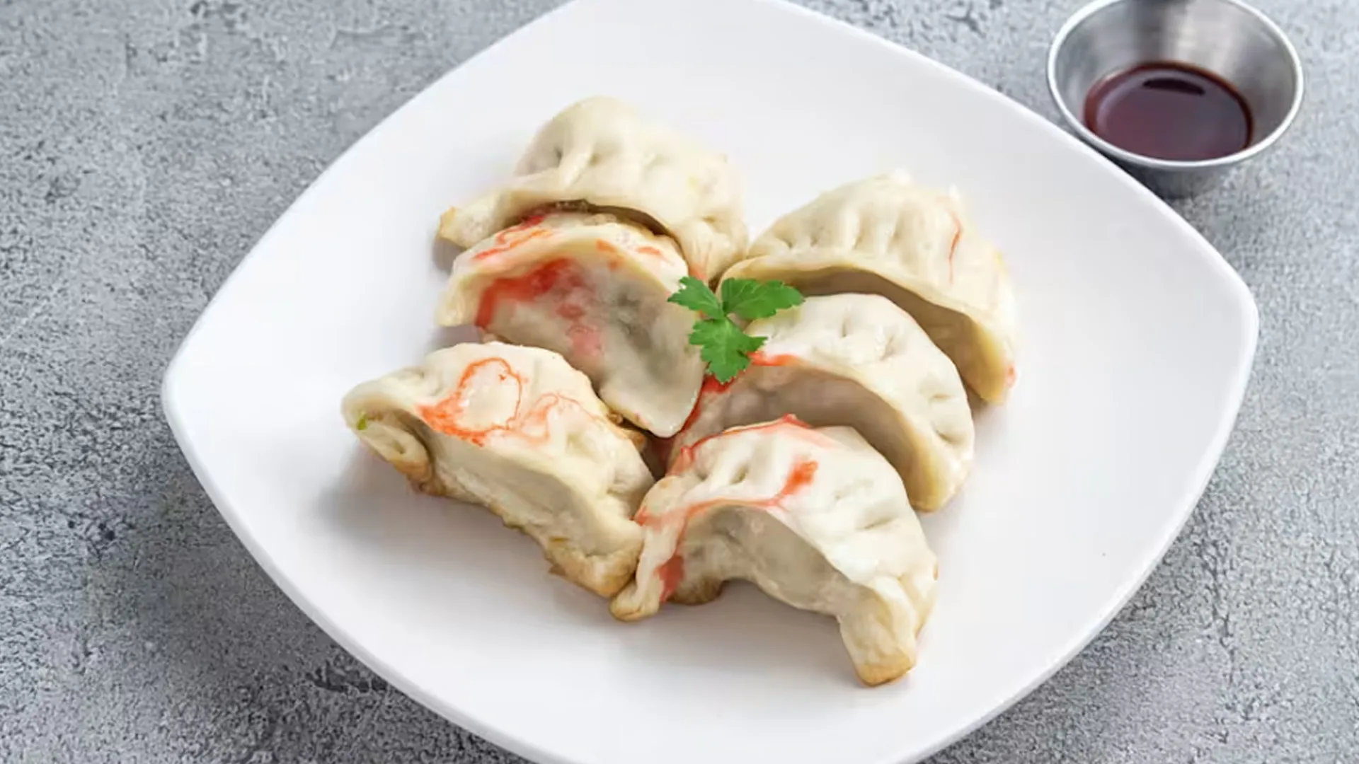 Six pan-fried potstickers with juicy pork filling and chili dipping sauce at Cheung Hing, a Chinese Restaurant in San Francisco